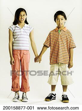 Stock Photography - boy and girl (7-9) 
holding hands, 
making faces (digital 
composite). fotosearch 
- search stock 
photos, pictures, 
images, and photo 
clipart