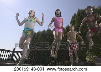 Stock Photography - children (10-12) 
jumping in swimming 
pool. fotosearch 
- search stock 
photos, pictures, 
images, and photo 
clipart