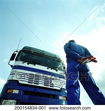 Stock Photography - driver standing 
in front of lorry, 
rear view, low 
angle view. fotosearch 
- search stock 
photos, pictures, 
images, and photo 
clipart