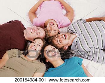 Stock Photography - five young adults 
lying head to 
head in circle, 
smiling, elevated 
view. fotosearch 
- search stock 
photos, pictures, 
images, and photo 
clipart
