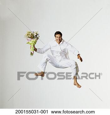 Stock Photography - young man jumping, 
holding bunch 
of flowers, portrait. 
fotosearch - search 
stock photos, 
pictures, images, 
and photo clipart