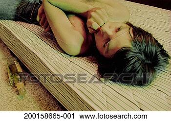 Stock Photography - young man lying 
on bare mattress, 
empty liquor bottle 
on floor. fotosearch 
- search stock 
photos, pictures, 
images, and photo 
clipart
