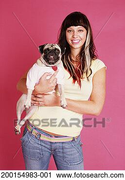 Stock Photography - young woman holding 
pug, portrait. 
fotosearch - search 
stock photos, 
pictures, images, 
and photo clipart