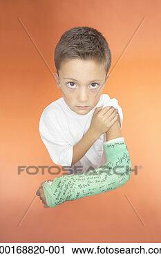Stock Photography - boy (7-9) lifting 
sleeve to show 
cast on arm, elevated 
view. fotosearch 
- search stock 
photos, pictures, 
images, and photo 
clipart