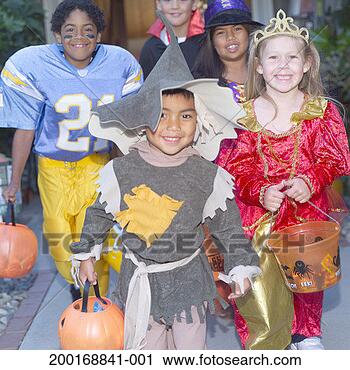Stock Photography - children (4-8) 
in halloween costumes 
trick-or-treating. 
fotosearch - search 
stock photos, 
pictures, images, 
and photo clipart