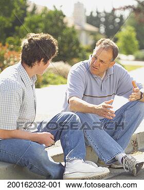 Stock Photography - father and teen 
son (15-17) sitting 
on curb, having 
discussion. fotosearch 
- search stock 
photos, pictures, 
images, and photo 
clipart