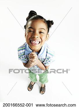 Stock Photography - girl (6-8) smiling, 
hands clasped, 
elevated view 
(digital enhancement). 
fotosearch - search 
stock photos, 
pictures, images, 
and photo clipart