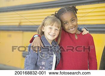 Stock Photography - girls (7-9) standing 
with arms around 
each other by 
school bus. fotosearch 
- search stock 
photos, pictures, 
images, and photo 
clipart