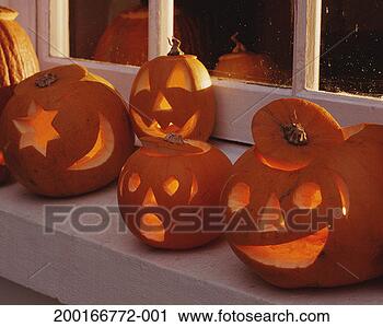 Stock Photography - illuminated pumpkin 
lanterns on in 
window sill. fotosearch 
- search stock 
photos, pictures, 
images, and photo 
clipart