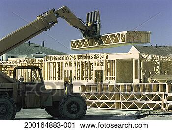 Stock Photography - man operating 
heavy equipment 
at prefabricated 
home construction 
site. fotosearch 
- search stock 
photos, pictures, 
images, and photo 
clipart