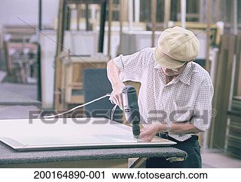 Stock Photography - mature man constructing 
picture frame 
in shop. fotosearch 
- search stock 
photos, pictures, 
images, and photo 
clipart