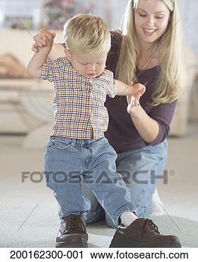 Stock Photography - mother helping 
baby boy (12-15 
months) walk in 
father's shoes. 
fotosearch - search 
stock photos, 
pictures, images, 
and photo clipart