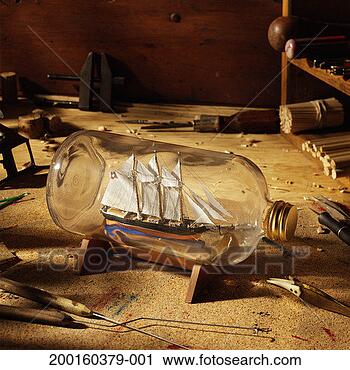 Stock Photography - ship in bottle 
surrounded by 
hand tools, elevated 
view. fotosearch 
- search stock 
photos, pictures, 
images, and photo 
clipart