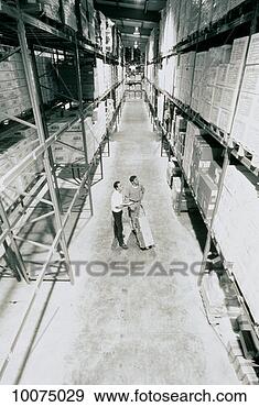 Stock Photograph - 2 workers in large 
warehouse. fotosearch 
- search stock 
photos, pictures, 
images, and photo 
clipart
