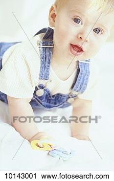 Stock Photography - baby in overalls 
on bed with keys. 
fotosearch - search 
stock photos, 
pictures, images, 
and photo clipart