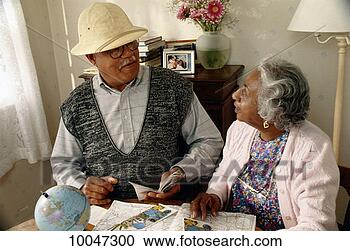 Stock Photography - black older couple 
planning vacation. 
fotosearch - search 
stock photos, 
pictures, images, 
and photo clipart