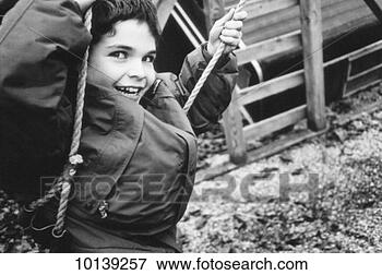 Picture - boy (9-11) playing 
on swing, close-up 
(b&w). fotosearch 
- search stock 
photos, pictures, 
images, and photo 
clipart
