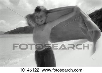 Stock Photo - boy at beach holding 
towel, cape, st 
john, us virgin 
islands. fotosearch 
- search stock 
photos, pictures, 
images, and photo 
clipart