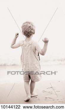 Stock Photo - boy in overall 
shorts on beach. 
fotosearch - search 
stock photos, 
pictures, images, 
and photo clipart
