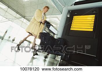 Stock Photography - businesswoman 
rushing to catch 
flight. fotosearch 
- search stock 
photos, pictures, 
images, and photo 
clipart