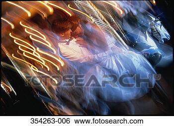 Stock Photo - couple in evening 
wear embracing 
on merry-go-round 
(blurred motion). 
fotosearch - search 
stock photos, 
pictures, images, 
and photo clipart