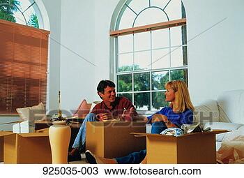 Stock Photo - couple taking 
a break from unpacking 
boxes in new home. 
fotosearch - search 
stock photos, 
pictures, images, 
and photo clipart