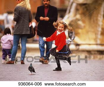 Stock Photo - girl (5-7) in 
red sweater, chasing 
pigeons, outdoors. 
fotosearch - search 
stock photos, 
pictures, images, 
and photo clipart