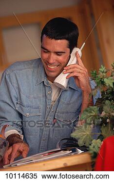Stock Image - hispanic man on 
phone in santa 
fe, new mexico. 
fotosearch - search 
stock photos, 
pictures, images, 
and photo clipart