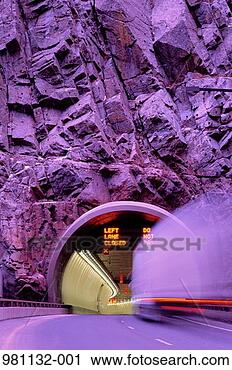 Stock Photography - lorry entering 
tunnel in cliff-face 
long exposue with 
violet cast. fotosearch 
- search stock 
photos, pictures, 
images, and photo 
clipart