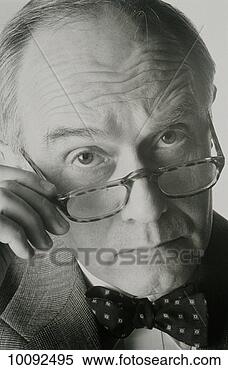 Stock Image - man looking over 
top of glasses 
at viewer. fotosearch 
- search stock 
photos, pictures, 
images, and photo 
clipart