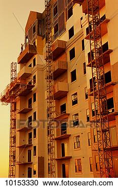 Stock Photography - man working at 
construction site, 
low angle view. 
fotosearch - search 
stock photos, 
pictures, images, 
and photo clipart