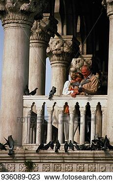 Stock Photo - mature couple 
standing on balcony 
feeding pigeons. 
fotosearch - search 
stock photos, 
pictures, images, 
and photo clipart