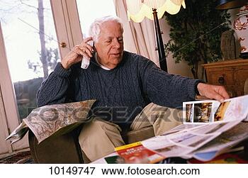 Picture - mature man on 
phone making travel 
plans. fotosearch 
- search stock 
photos, pictures, 
images, and photo 
clipart