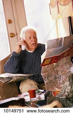 Stock Photography - mature man on 
phone making travel 
plans. fotosearch 
- search stock 
photos, pictures, 
images, and photo 
clipart