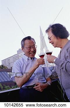 Stock Image - middle aged asian 
couple drinking 
wine. fotosearch 
- search stock 
photos, pictures, 
images, and photo 
clipart