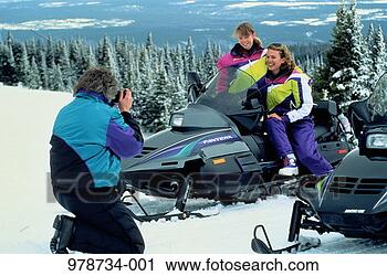 Stock Photography - mother and daughter 
(8-10) having 
photo taken on 
snowmobile by 
father. fotosearch 
- search stock 
photos, pictures, 
images, and photo 
clipart
