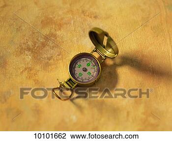 Stock Photo - pocket compass 
on yellow canvas. 
fotosearch - search 
stock photos, 
pictures, images, 
and photo clipart