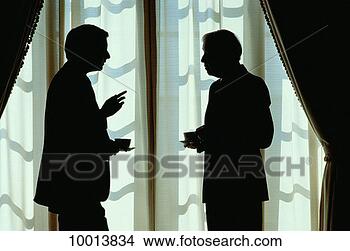 Stock Photo - silhouette of 
a businessmen 
in front of window. 
fotosearch - search 
stock photos, 
pictures, images, 
and photo clipart