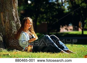 Stock Photography - teenage college 
student (17-19) 
studying under 
tree. fotosearch 
- search stock 
photos, pictures, 
images, and photo 
clipart