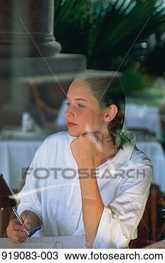 Stock Photo - woman in white 
seen through window 
of cafe as she 
writes a letter. 
fotosearch - search 
stock photos, 
pictures, images, 
and photo clipart