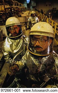 Stock Photography - workers in heat 
resistant suits, 
turning molten 
metal into ingots. 
fotosearch - search 
stock photos, 
pictures, images, 
and photo clipart