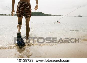 Stock Photograph - young man in flippers, 
st john, us virgin 
islands. fotosearch 
- search stock 
photos, pictures, 
images, and photo 
clipart