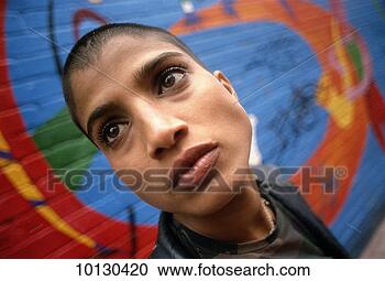 Stock Photography - young woman with 
shaven head, street 
grafitti. fotosearch 
- search stock 
photos, pictures, 
images, and photo 
clipart