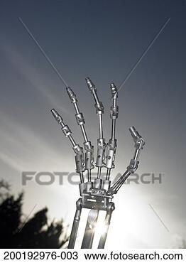 Stock Photo - robotic hand against 
grey sky, sun 
flare through 
arm. fotosearch 
- search stock 
photos, pictures, 
images, and photo 
clipart