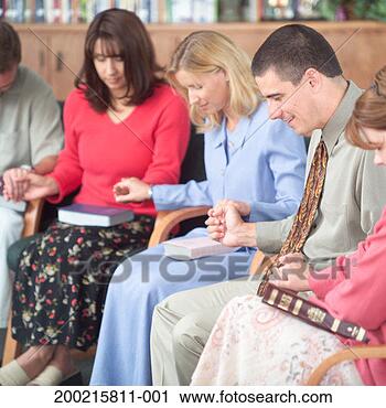 Stock Photography - group of women 
and men praying, 
holding hands. 
fotosearch - search 
stock photos, 
pictures, images, 
and photo clipart
