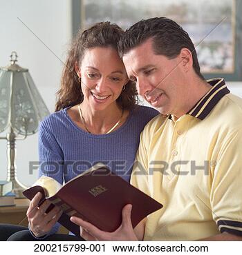 Stock Photography - man and woman 
reading bible. 
fotosearch - search 
stock photos, 
pictures, images, 
and photo clipart