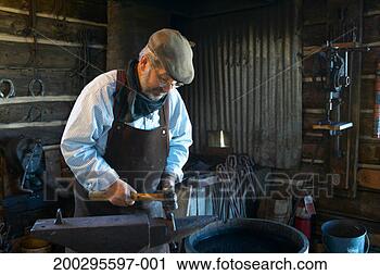Stock Photography - blacksmith working 
on horseshoe in 
shop. fotosearch 
- search stock 
photos, pictures, 
images, and photo 
clipart