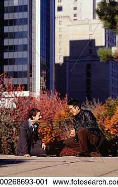 Stock Photography - businesswoman 
sitting outside 
in city using 
laptop, laughing 
with man. fotosearch 
- search stock 
photos, pictures, 
images, and photo 
clipart