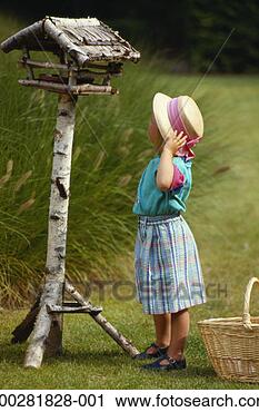 Stock Photography - girl (4-5) looking 
at bird house, 
rear view. fotosearch 
- search stock 
photos, pictures, 
images, and photo 
clipart