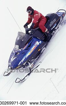 Stock Photography - person riding 
snowmobile, elevated 
view. fotosearch 
- search stock 
photos, pictures, 
images, and photo 
clipart